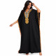 Djellaba femme pompons noire avec broderies orientales et coupe ample.
